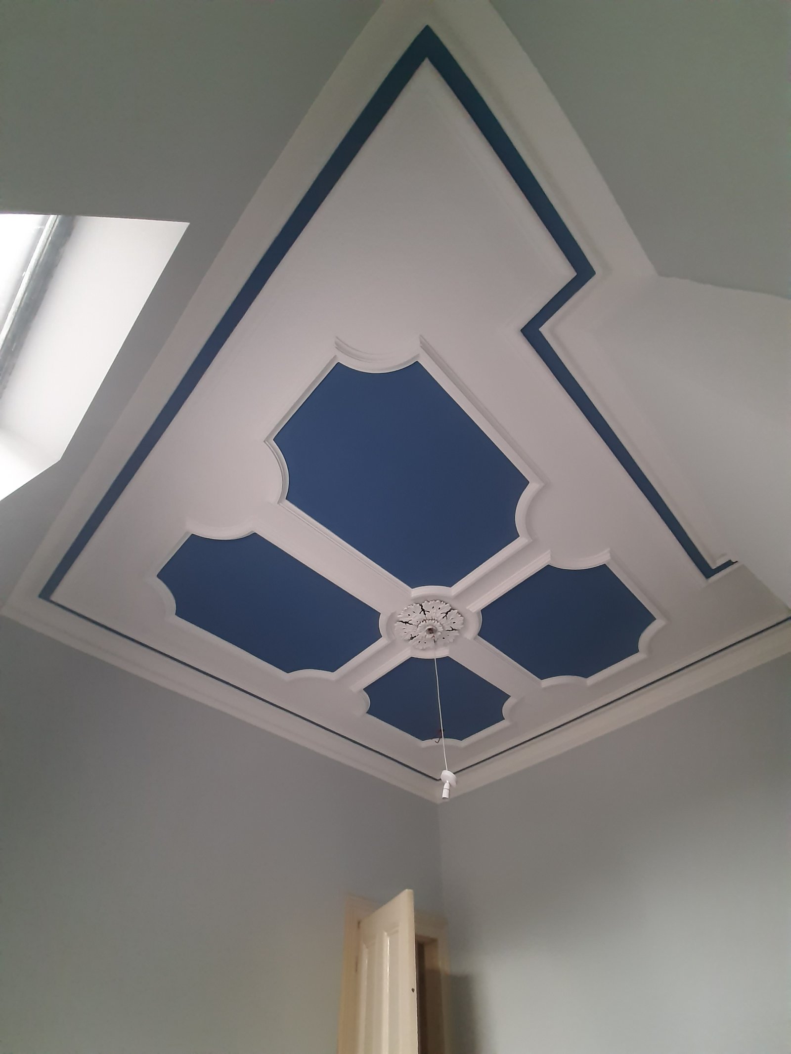 Ceiling panelling painted in navy and white