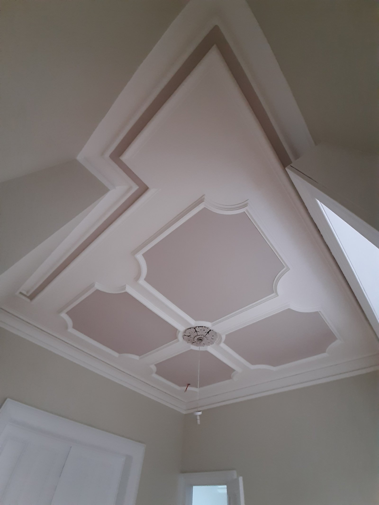 Ceiling panelling painted in soft grey and white