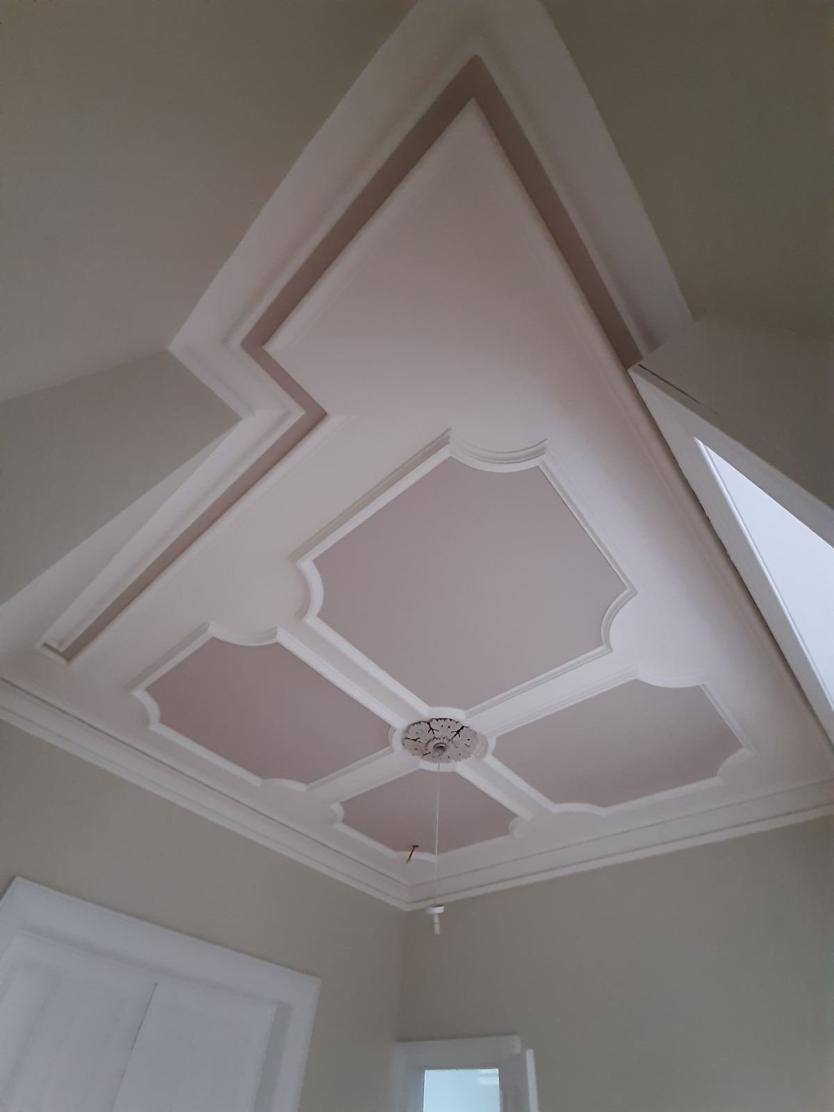 Restored period ceiling mouldings in a Dublin home, filled, sanded and finished in soft white and blush