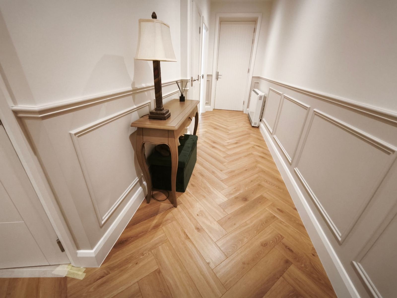 Hallway wainscoting and skirting hand-painted soft white in a Dublin home, herringbone floor
