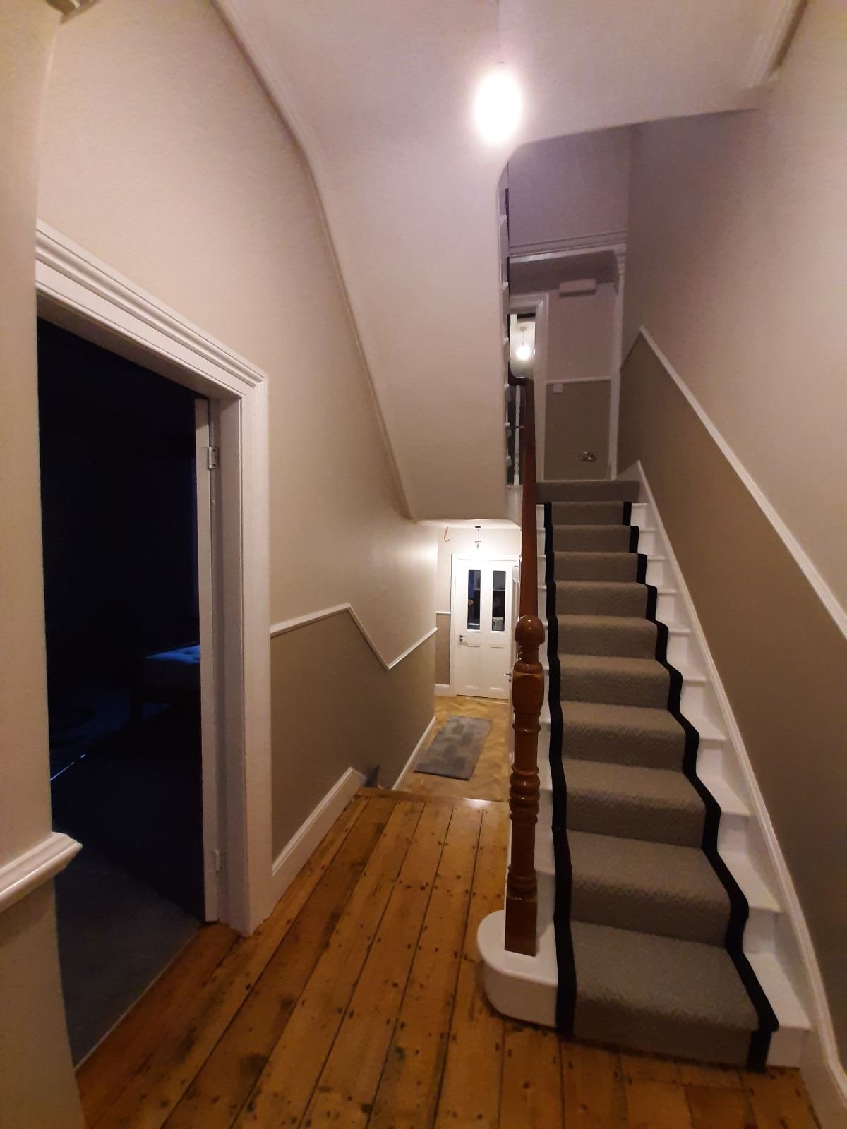 The same Dublin hallway and stairs finished, walls sanded smooth and painted with a two-tone dado line