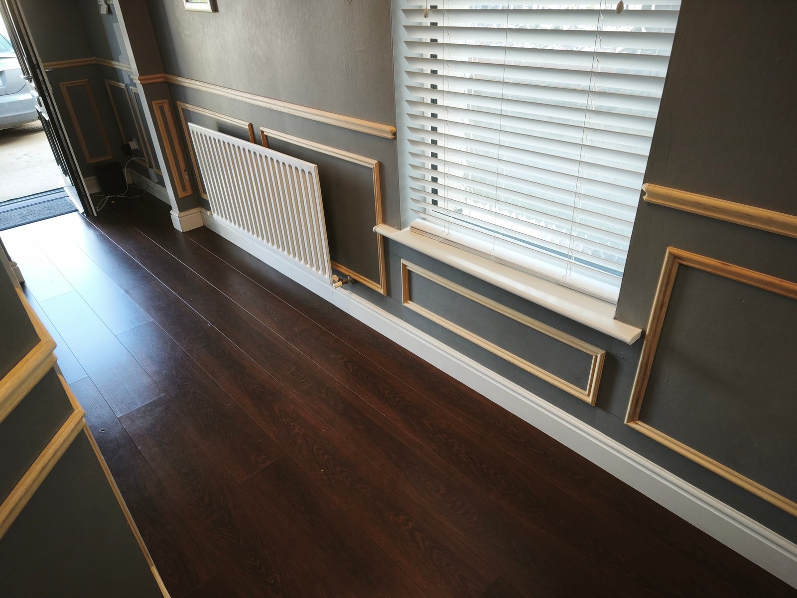 Wainscoting panels in progress along a hallway