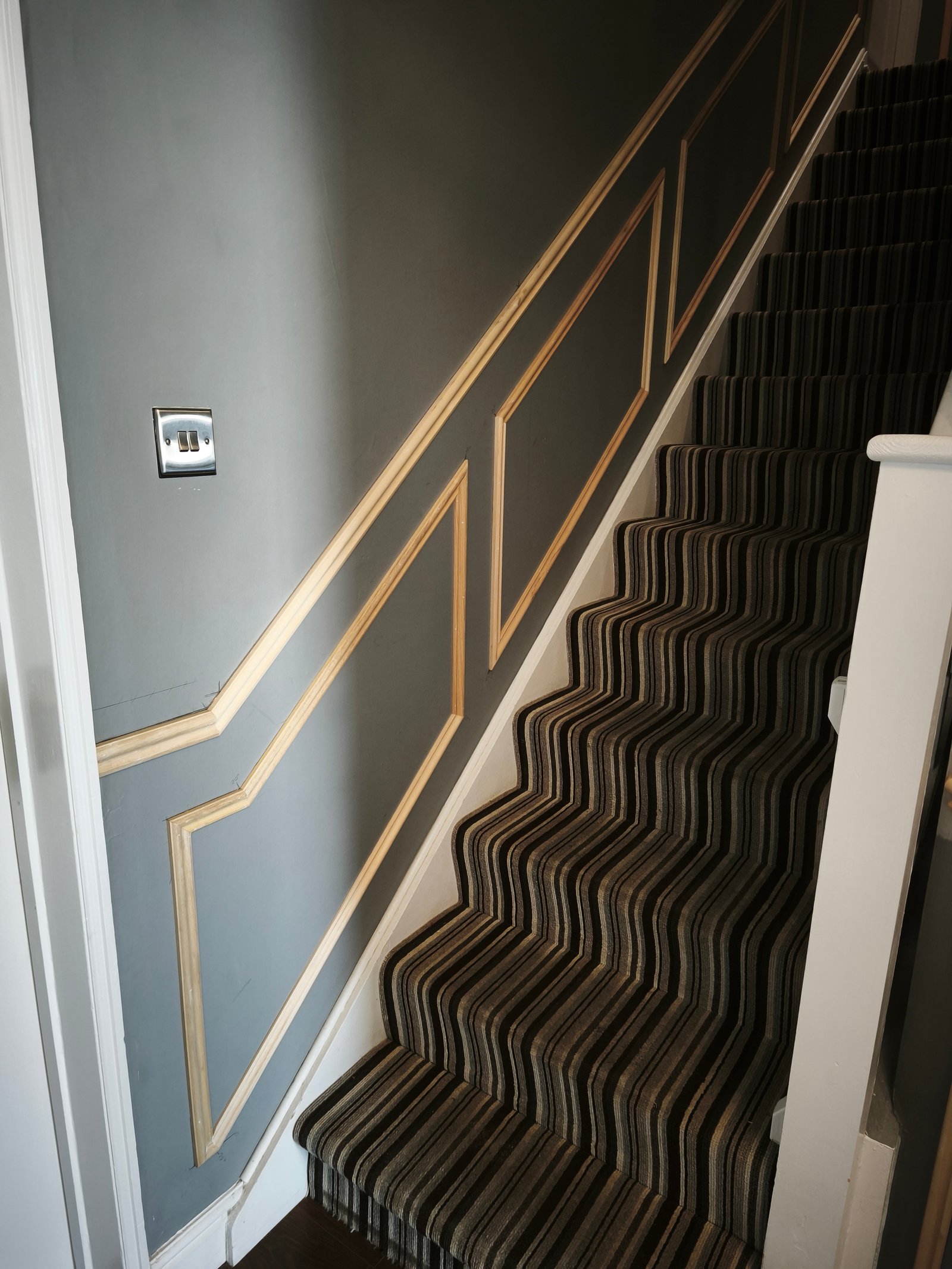 Wainscoting frame layout on a stairwell wall
