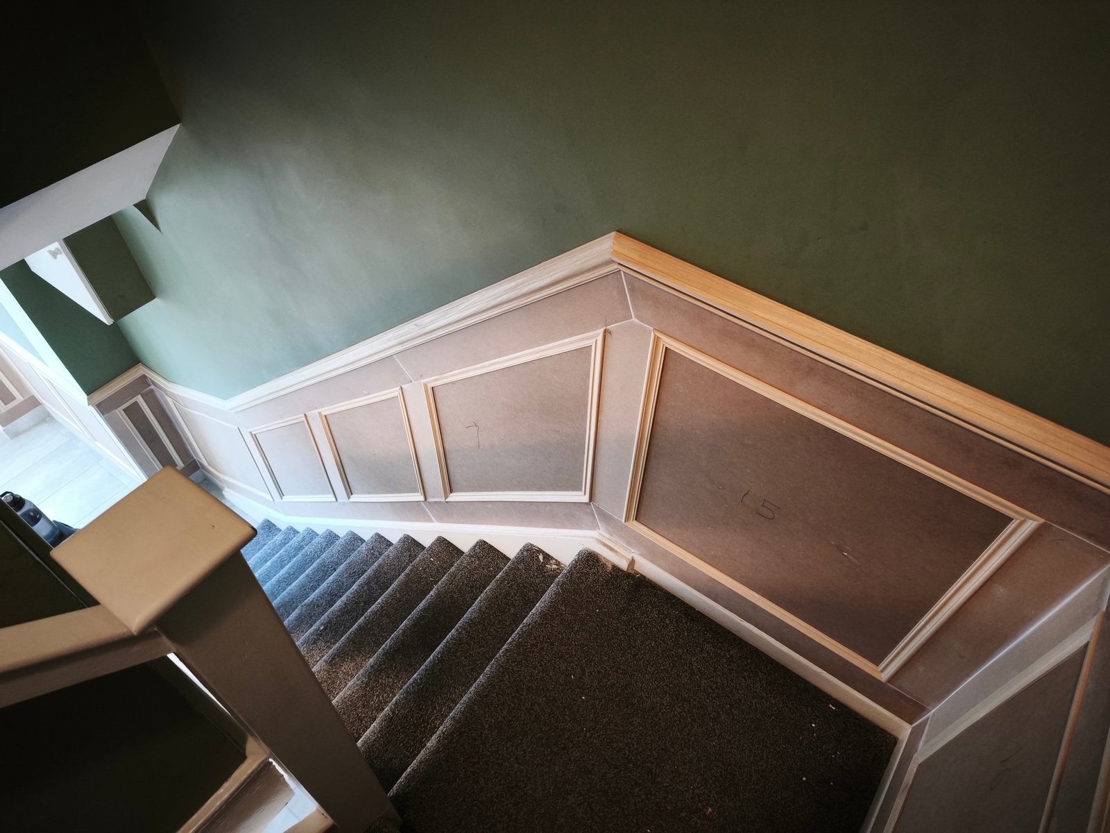 Wall covering panelling down a stairwell